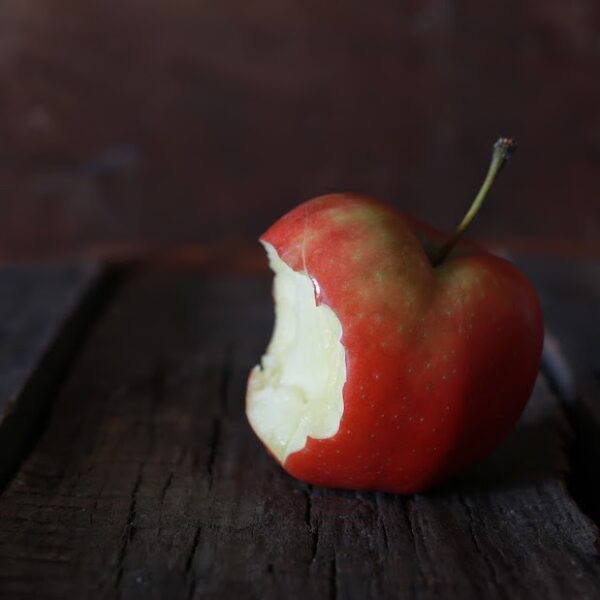 bitten apple on a wooden background